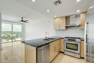 Kitchen with a sink, tasteful backsplash, stainle