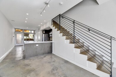 Stairway featuring finished concrete floors, rece