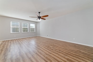 Spacious living room opens to the dining room & kitchen. Tons of natural lighting with the wall of windows overlooking the backyard.