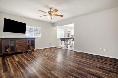 Living room featuring ceiling fan, laminate hardwo