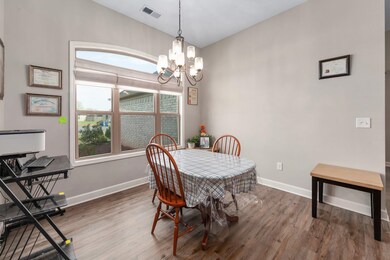 Dining room with visible vents, baseboards, a chan