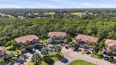 Aerial perspective of suburban area with a forest and a nearby body of water