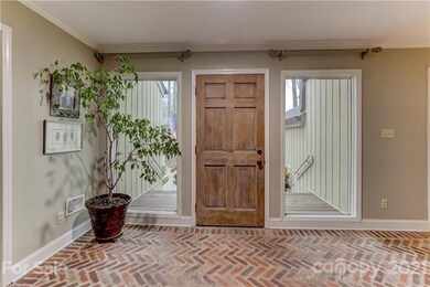 Brick floored foyer with big beautiful windows