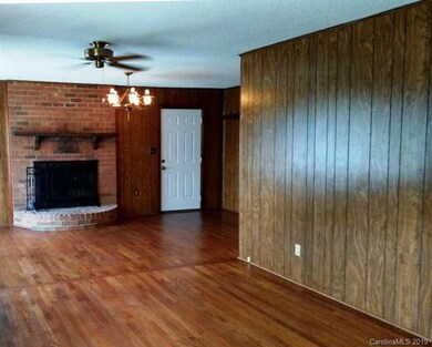 Large family room with wood burning fireplace.