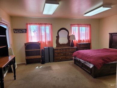 Carpeted bedroom with multiple windows