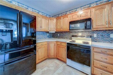 Newish fridge, tile backsplash, granite countertop