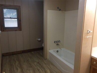 Full bath featuring wood finished floors, vanity, and  shower combination