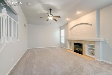 Unfurnished living room featuring a ceiling fan, carpet floors, a tiled fireplace, recessed lighting, and built in features