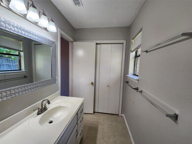 Bathroom with tile patterned floors and vanity