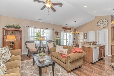 Living area featuring lofted ceiling, light wood-s