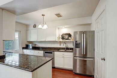 Bright kitchen with granite counters and room to t