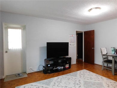 Living room featuring a textured ceiling