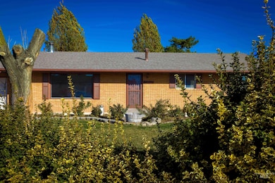 Single story home featuring a shingled roof and brick siding