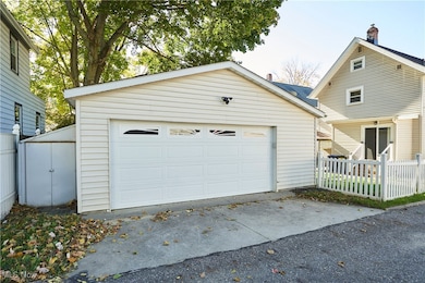 Newer 2 car garage with vinyl siding