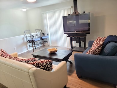 Living room with wood finished floors and baseboar