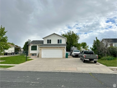 View of front facade featuring driveway, a garage, and roof with shingles