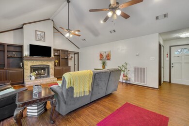 The family room has bookcases with cabinets below
