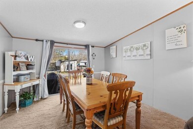 Carpeted dining area featuring lofted ceiling, orn
