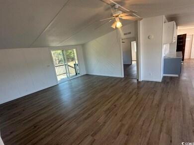 Unfurnished living room featuring lofted ceiling, 