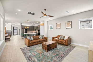 View from the living room to the front of the home. The first floor features wood-look tile in a light, natural shade for timeless appeal. Trends can change over time, but this flooring selection will outlast them all and can coordinate with any color scheme due to the designer touch that blends warm and cool tones with low contrast.