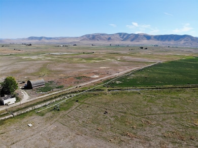 Overview of rural landscape featuring a mountainous background