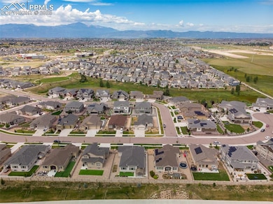 Aerial overview of property's location with a mountain backdrop and nearby suburban area