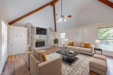 Living room with beam ceiling, ceiling fan, high v