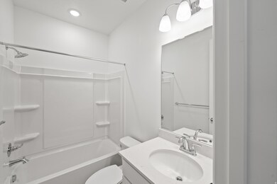 Full bath featuring washtub / shower combination, vanity, and recessed lighting