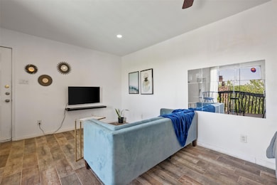 Living area featuring wood finished floors, ceili