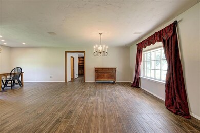 Unfurnished room with a chandelier, dark wood-style flooring, baseboards, and recessed lighting
