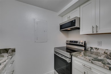 Kitchen with stainless steel electric stove, elect