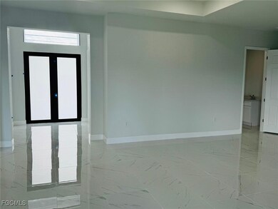 Empty room featuring light marble finish floors and french doors