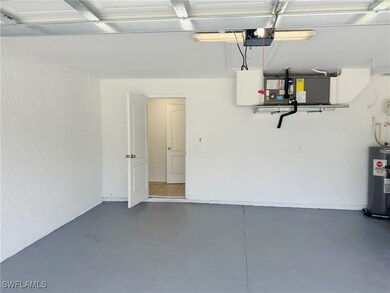 Garage featuring water heater and a garage door op