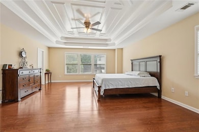 Bedroom featuring a tray ceiling, crown molding, v