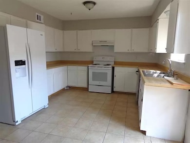 Kitchen with white appliances, under cabinet range