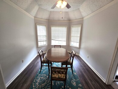 Dining space with a ceiling fan, dark wood-style f