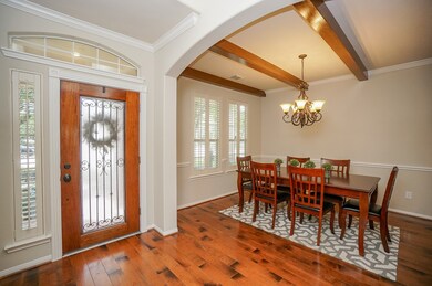 A grand entry with beautiful hardwood floors and arched doorways. The elegant formal dining room is just off the entry. The entire home has been freshly painted throughout in Accessible Beige.