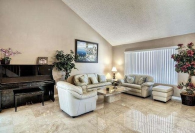 Formal Living Room: Travertine Flooring & Soaring 