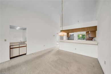 Living room view looking into dining and kitchen a