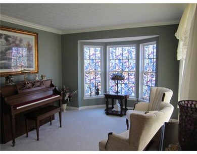 Living Room. THE LIVING ROOM HAS A BUMP OUT BAY WINDOW ON THE SIDE AS WELL AS THE FRONT WINDOW WHICH BRINGS IN LOTS OF LIGHT. THIS ROOM ALSO HAS A CROWN MOULDING.