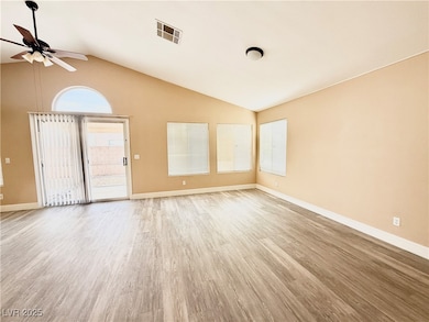 Spare room featuring ceiling fan, lofted ceiling,