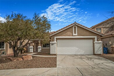 View of front of house with a garage, driveway, a