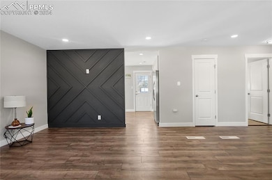 Spare room featuring dark wood-type flooring