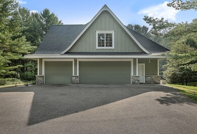 A wide asphalt driveway, with a built-in alarm, leads to the oversized, heated and insulated three-stall garage, complete with hot and cold water, and in-floor heat.