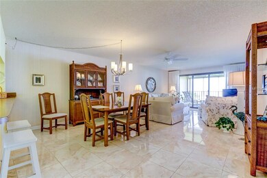 Dining and living areas with shiny newer floors