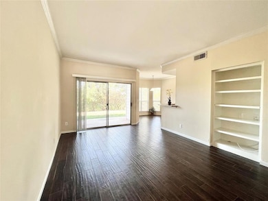Unfurnished living room featuring ornamental mold