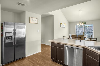 Kitchen overlooks the dining area with soaring ceilings! Really gives the space an open feel.