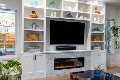 Bountiful built-ins perfect for books, art, etc. around cozy fireplace.