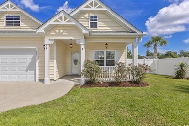 View of front of home with a porch and concrete driveway