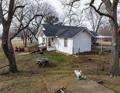 View of side of property with a carport